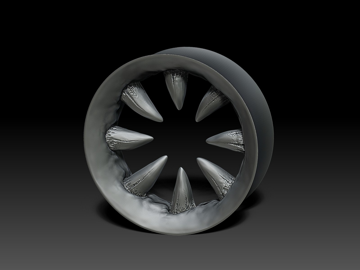 Front view of the fanged ear tunnel in titanium, showing the complete circular arrangement of sculpted teeth and the organic gum forms surrounding the opening.